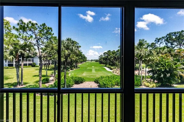 a view of a glass door with a yard from a balcony