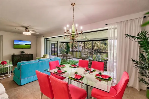 a dining room with furniture a chandelier and window