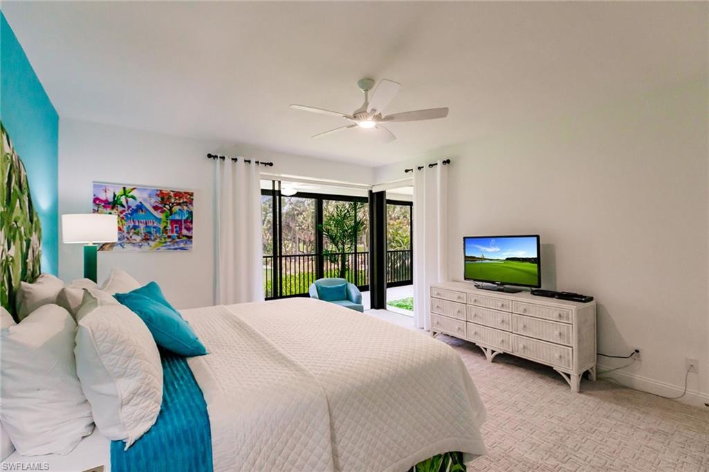 22 Cypress View Drive, Unit B22 Naples, FL 34113 - Photo 19 of 39 a bed room with a bed and a large window
