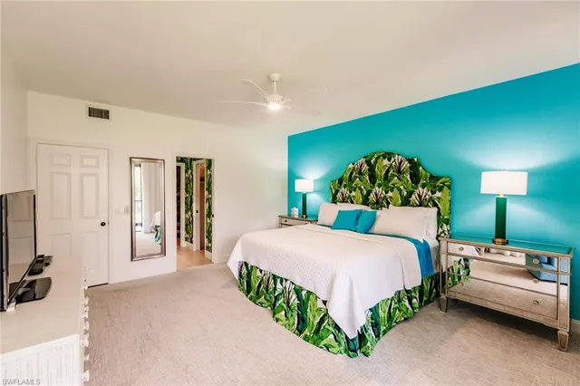 a bedroom with a bed and a large mirror