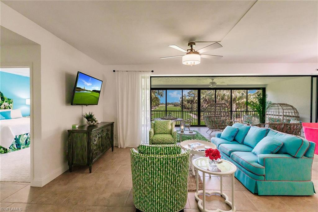 22 Cypress View Drive, Unit B22 Naples, FL 34113 - Photo 2 of 39 a living room with furniture and a flat screen tv