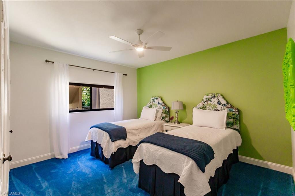 22 Cypress View Drive, Unit B22 Naples, FL 34113 - Photo 27 of 39 a bedroom with two beds and wooden floor