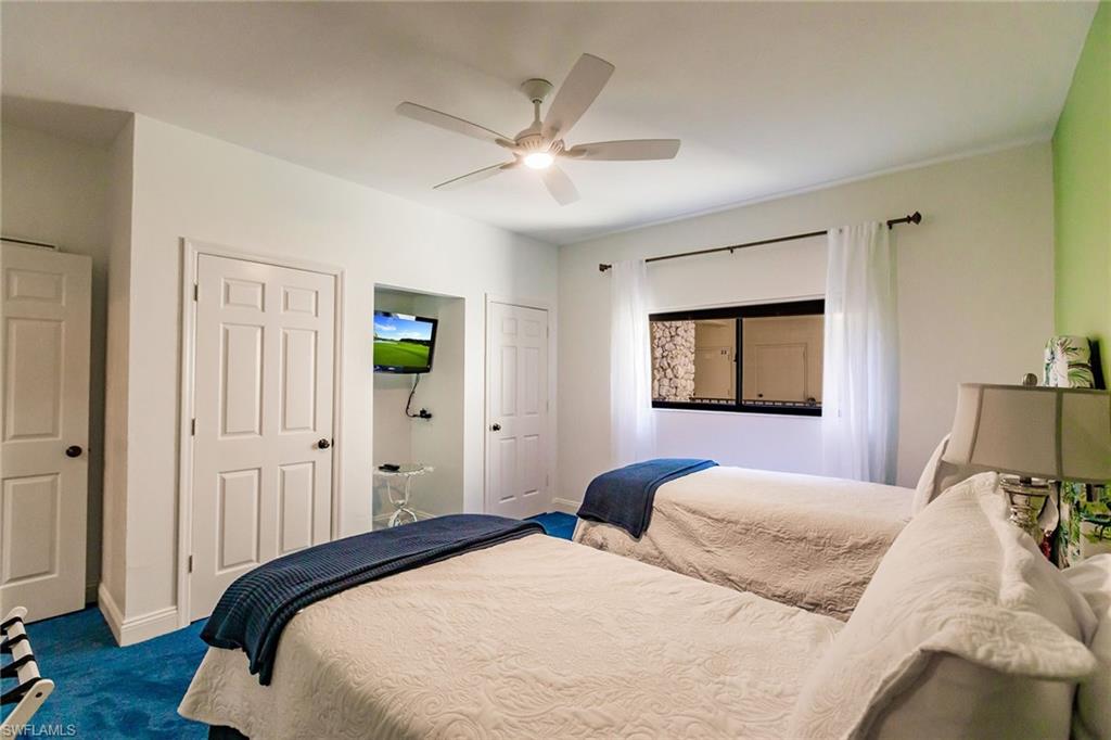 22 Cypress View Drive, Unit B22 Naples, FL 34113 - Photo 28 of 39 a bedroom with a large bed and a window