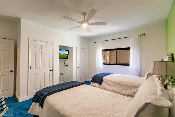 a bedroom with a large bed and a window