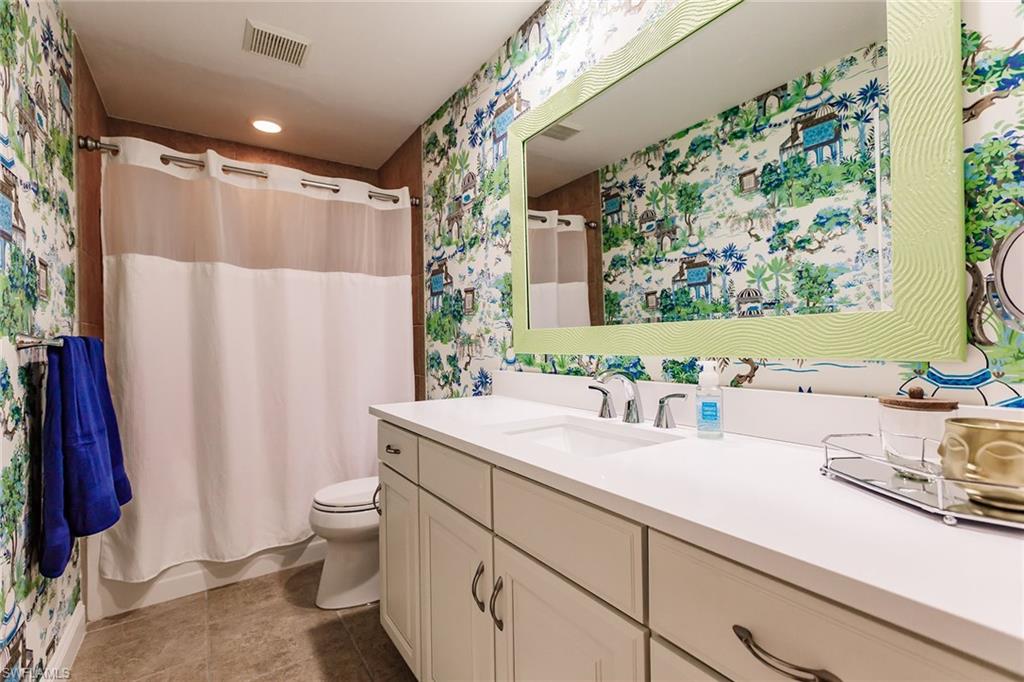 22 Cypress View Drive, Unit B22 Naples, FL 34113 - Photo 29 of 39 a bathroom with a sink and a mirror