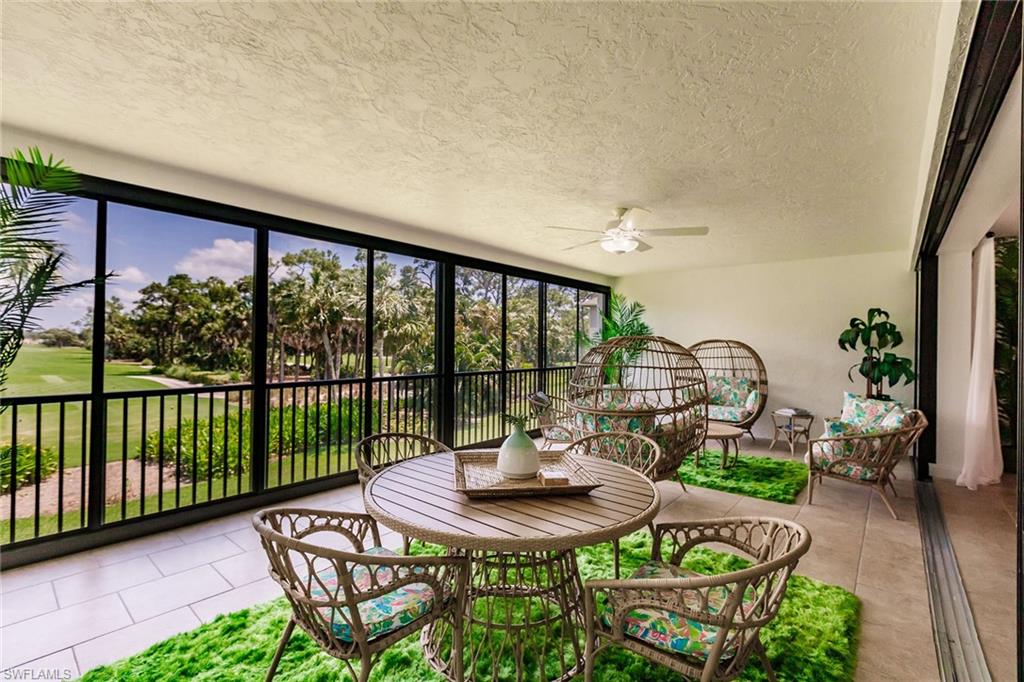 22 Cypress View Drive, Unit B22 Naples, FL 34113 - Photo 30 of 39 a living room with furniture and a floor to ceiling window