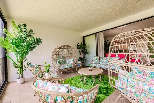 a view of a swimming pool with outdoor seating