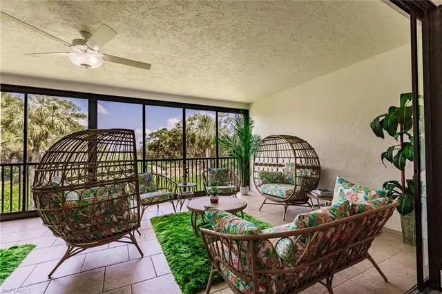 a view of a porch with furniture and garden