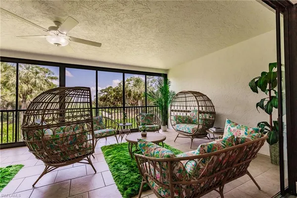 a view of a porch with furniture and garden