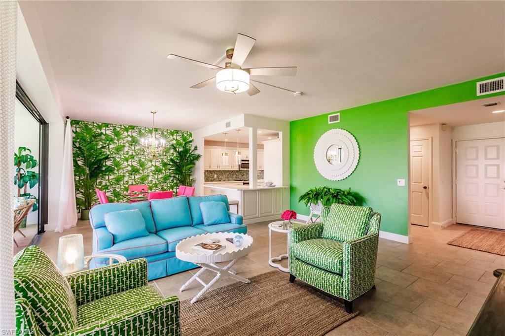 22 Cypress View Drive, Unit B22 Naples, FL 34113 - Photo 5 of 39 a living room with furniture and a large window