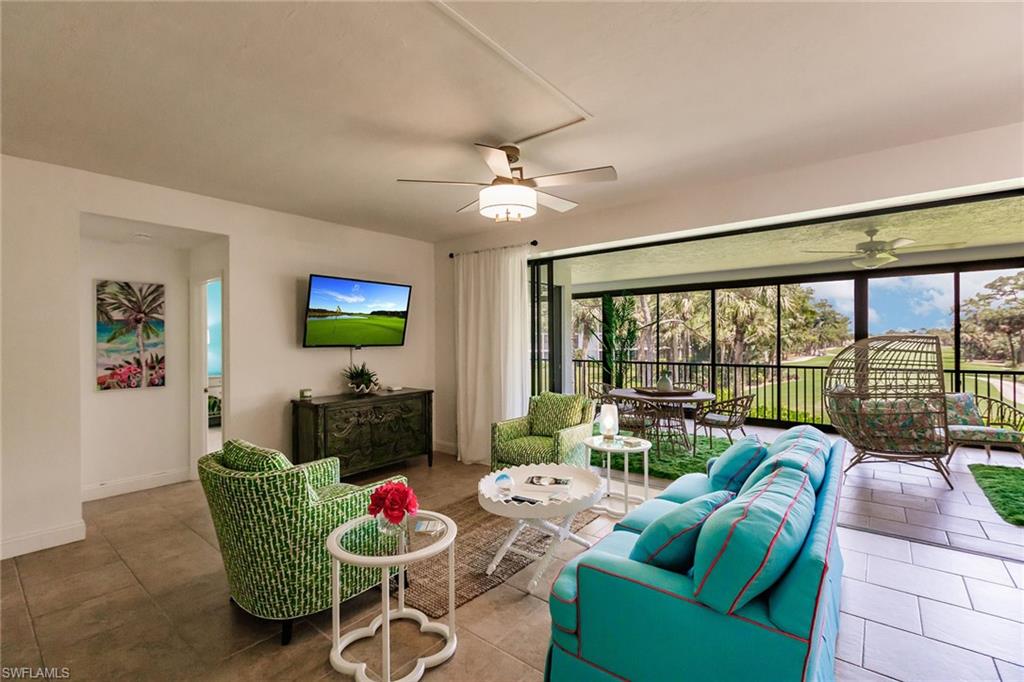 22 Cypress View Drive, Unit B22 Naples, FL 34113 - Photo 6 of 39 a living room with furniture a flat screen tv and a large window