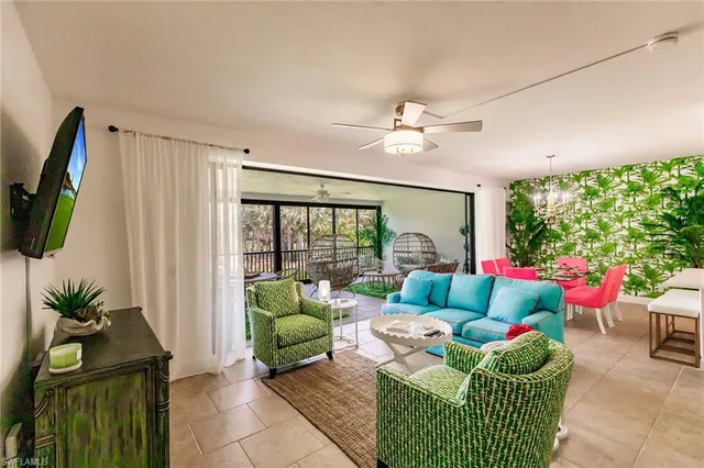 a living room with furniture fireplace and a large window
