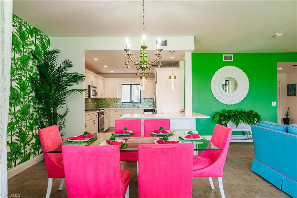 22 Cypress View Drive, Unit B22 Naples, FL 34113 - Photo 8 of 39 a view of a dining room with furniture and chandelier
