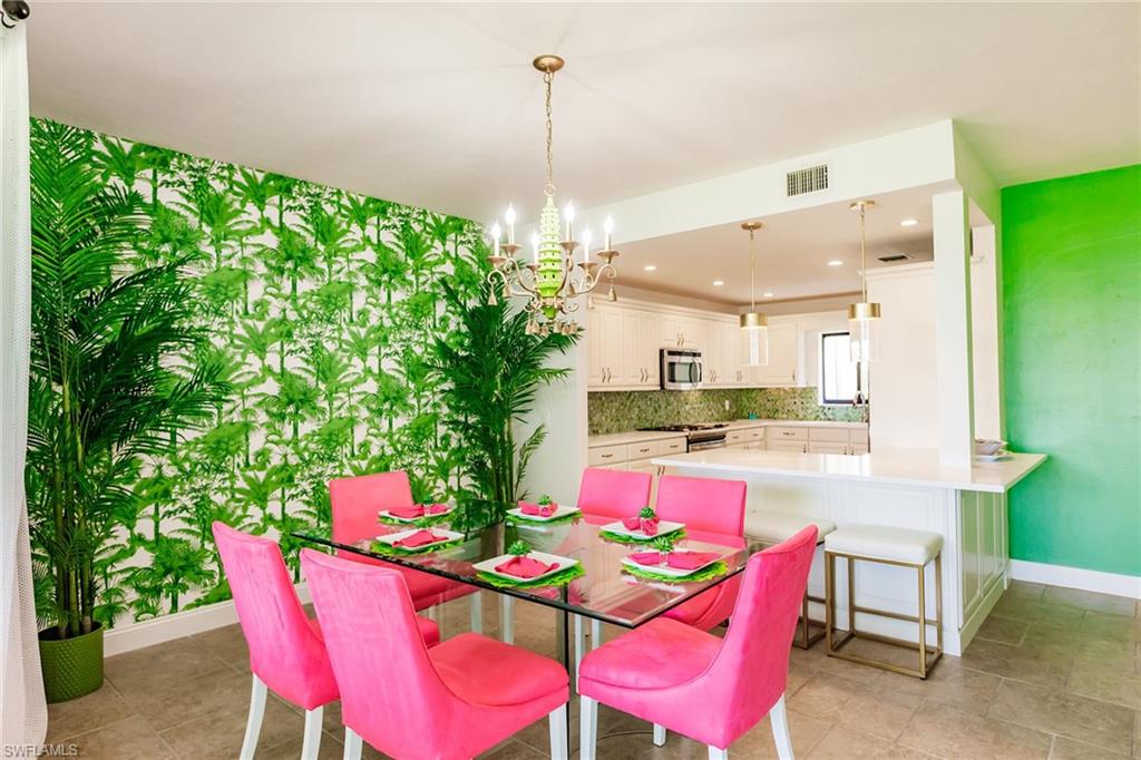 22 Cypress View Drive, Unit B22 Naples, FL 34113 - Photo 9 of 39 a dining room with a table and chairs
