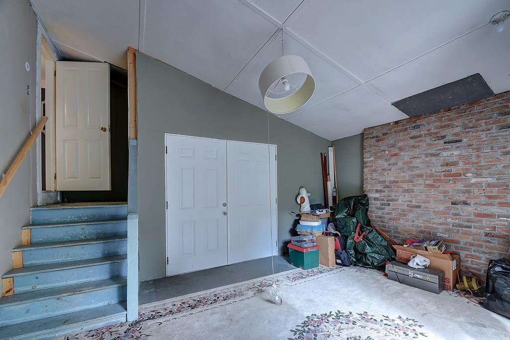 96 Shepard Road Sturbridge, MA 01566 - Photo 8 of 28 a view of a livingroom with stairs and a fireplace