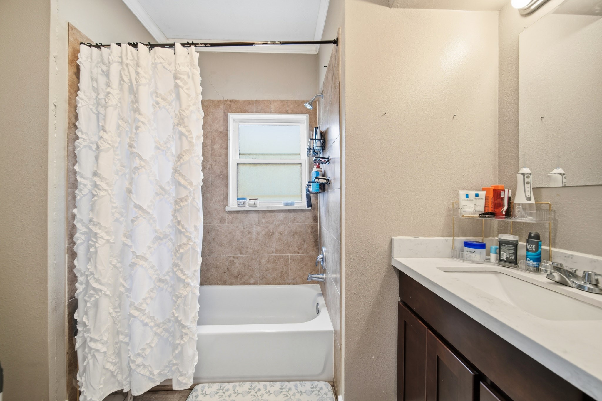 1302 20th Street Huntsville, TX 77340 - Photo 21 of 26 a bathroom with a bathtub sink vanity and mirror