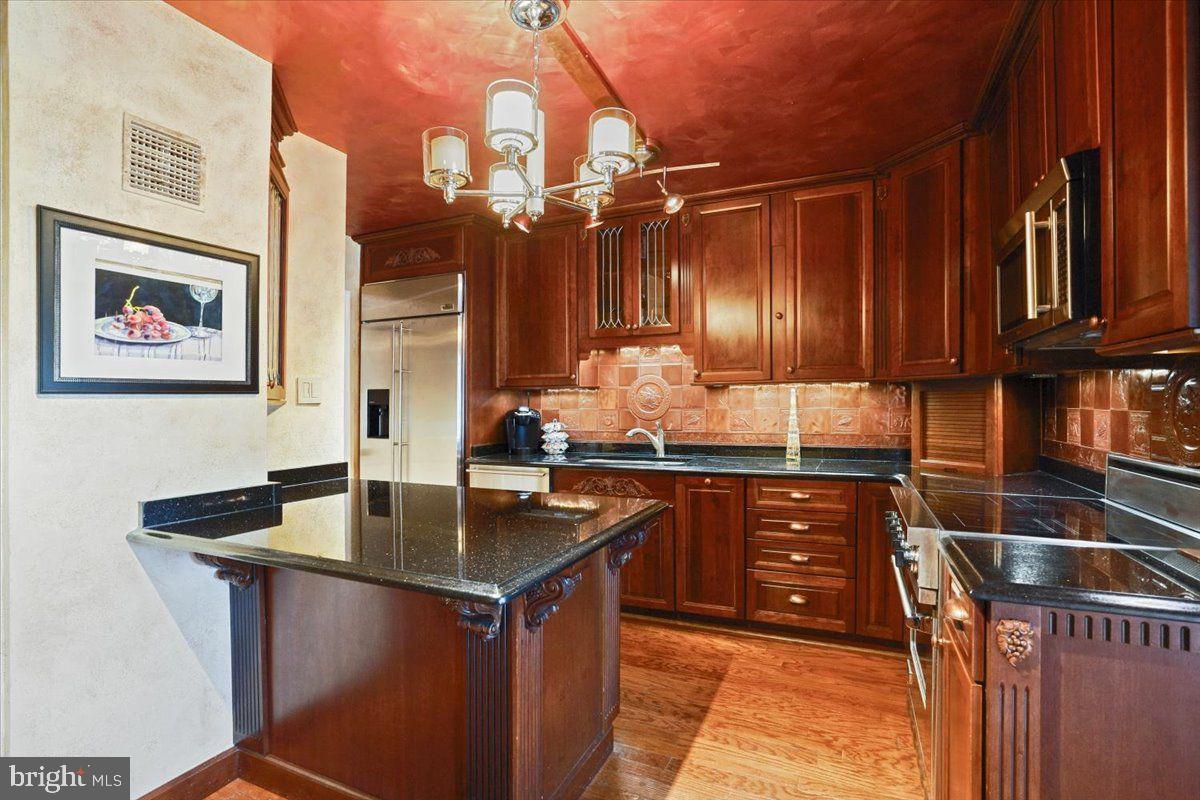 800 25th Street Northwest, Unit 504 Washington, DC 20037 - Photo 18 of 52 Elegant kitchen with rich wood tones.