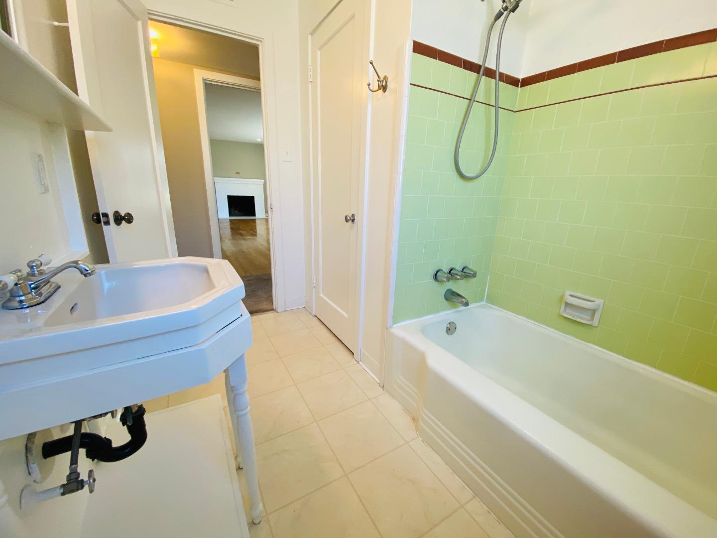 15107 Woodard Road San Jose, CA 95124 - Photo 14 of 20 a bathroom with a tub a sink and a shower