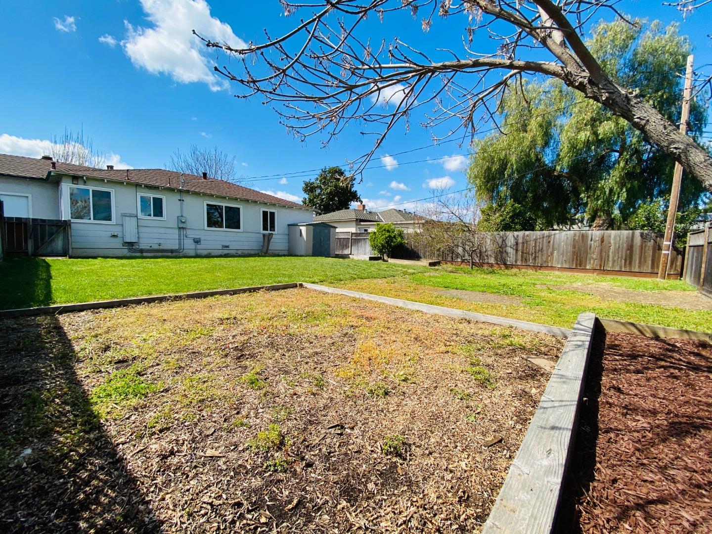 15107 Woodard Road San Jose, CA 95124 - Photo 18 of 20 a view of a house with a yard and a garage