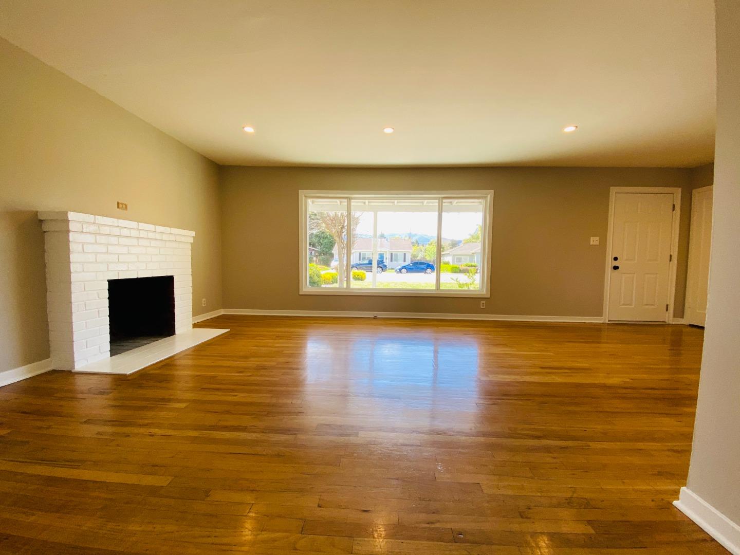 15107 Woodard Road San Jose, CA 95124 - Photo 5 of 20 a view of an empty room with window and wooden floor