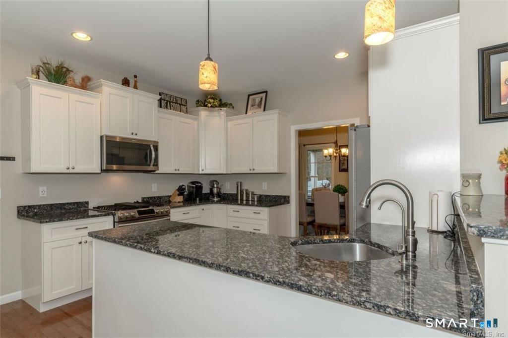 823 A Stone Road Windsor, CT 06095 - Photo 8 of 38 a kitchen with counter top space cabinets and stainless steel appliances