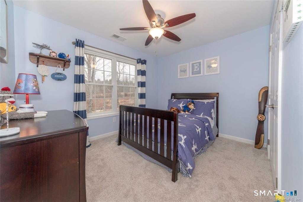 823 A Stone Road Windsor, CT 06095 - Photo 11 of 38 a bedroom with a bed and a chandelier