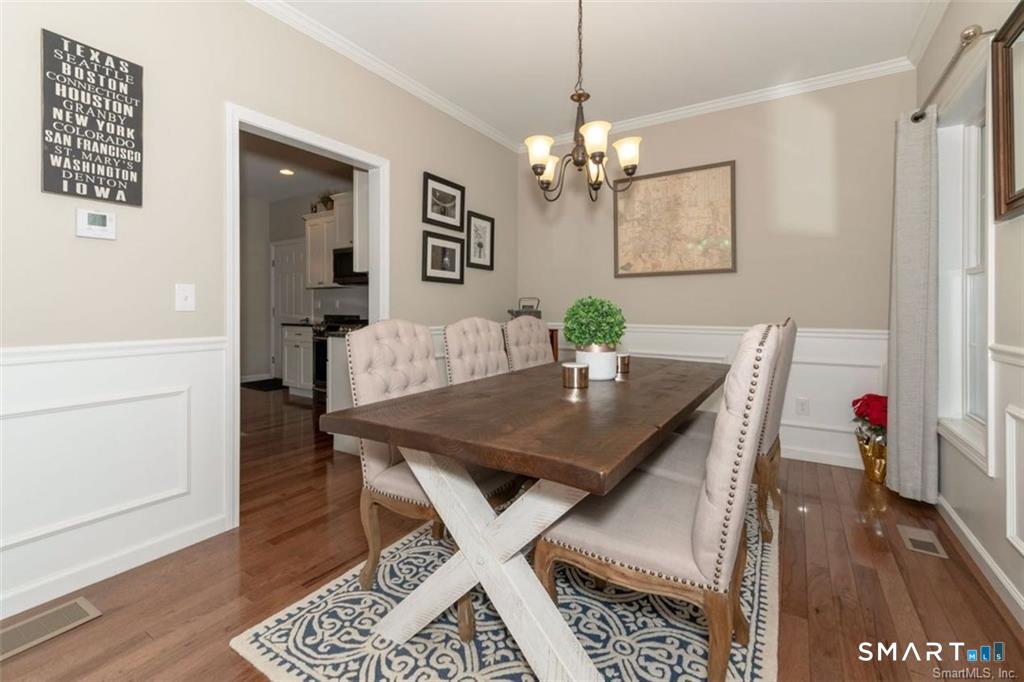 823 A Stone Road Windsor, CT 06095 - Photo 16 of 38 a view of a dining room with furniture and wooden floor