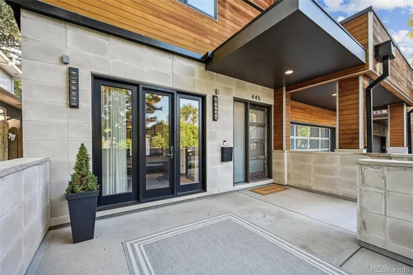a entryway view with a potted plant in front of a building