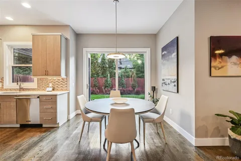 a dining room with furniture a chandelier and wooden floor