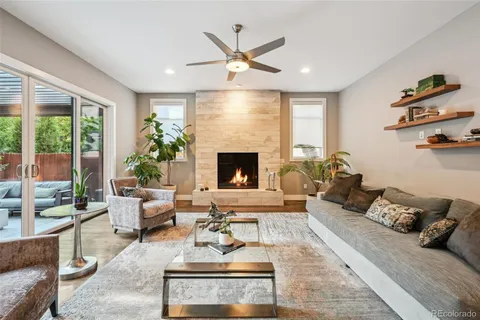 a living room with furniture fireplace and a large window
