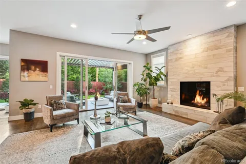 a living room with furniture fireplace and a large window