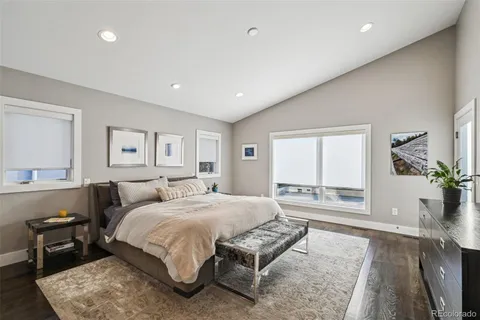 a spacious bedroom with a large bed and windows