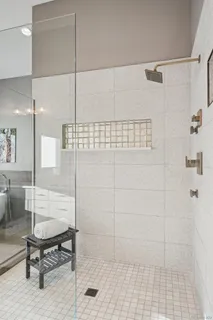 a white bath tub sitting in a bathroom next to a window
