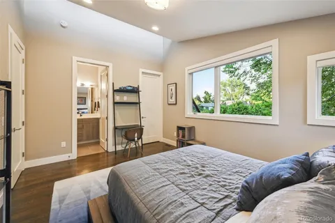 a bedroom with a bed window and a table