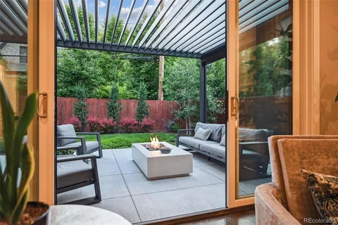 a outdoor living space with patio furniture and a grill