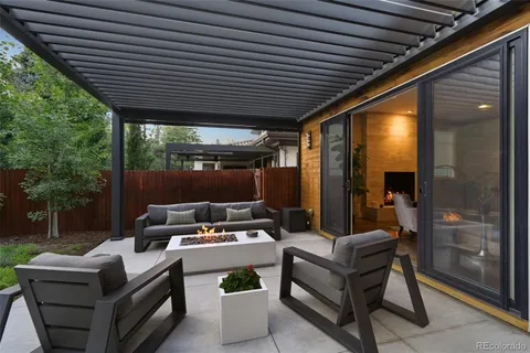 a view of a porch with furniture and floor to ceiling window