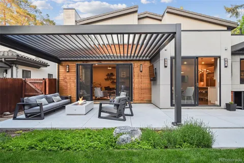 a view of a house with backyard porch and sitting area