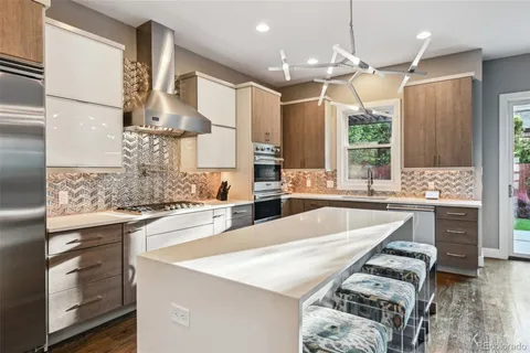 a large kitchen with granite countertop a stove and a sink