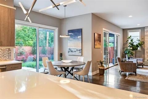 a view of a dining room with furniture and chandelier