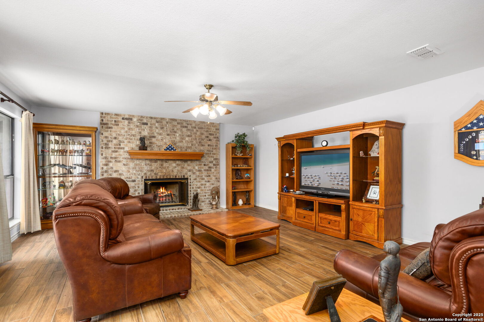 188 Guadalupe Ranch Lane Seguin, TX 78155 - Photo 12 of 40 a living room with furniture flat screen tv and fireplace