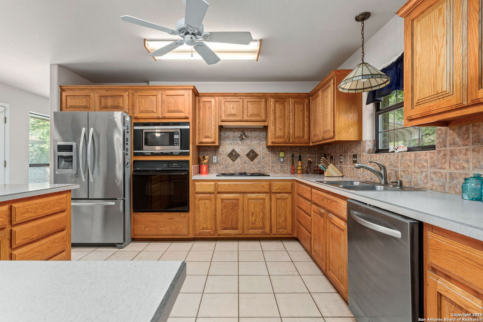 188 Guadalupe Ranch Lane Seguin, TX 78155 - Photo 16 of 40 a kitchen with stainless steel appliances granite countertop a refrigerator a sink dishwasher a stove and white cabinets