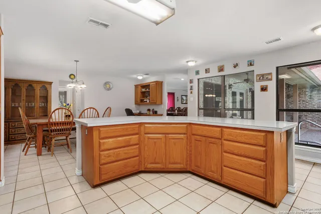 a large spacious bathroom with a granite countertop sink mirror and cabinets