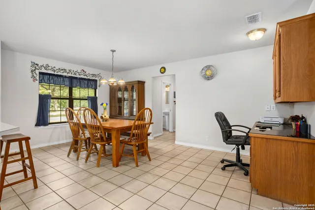 a dining room with furniture and window