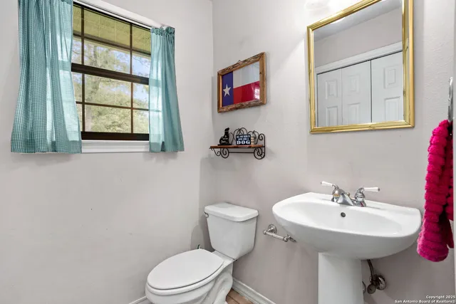 a bathroom with a sink a mirror and a toilet