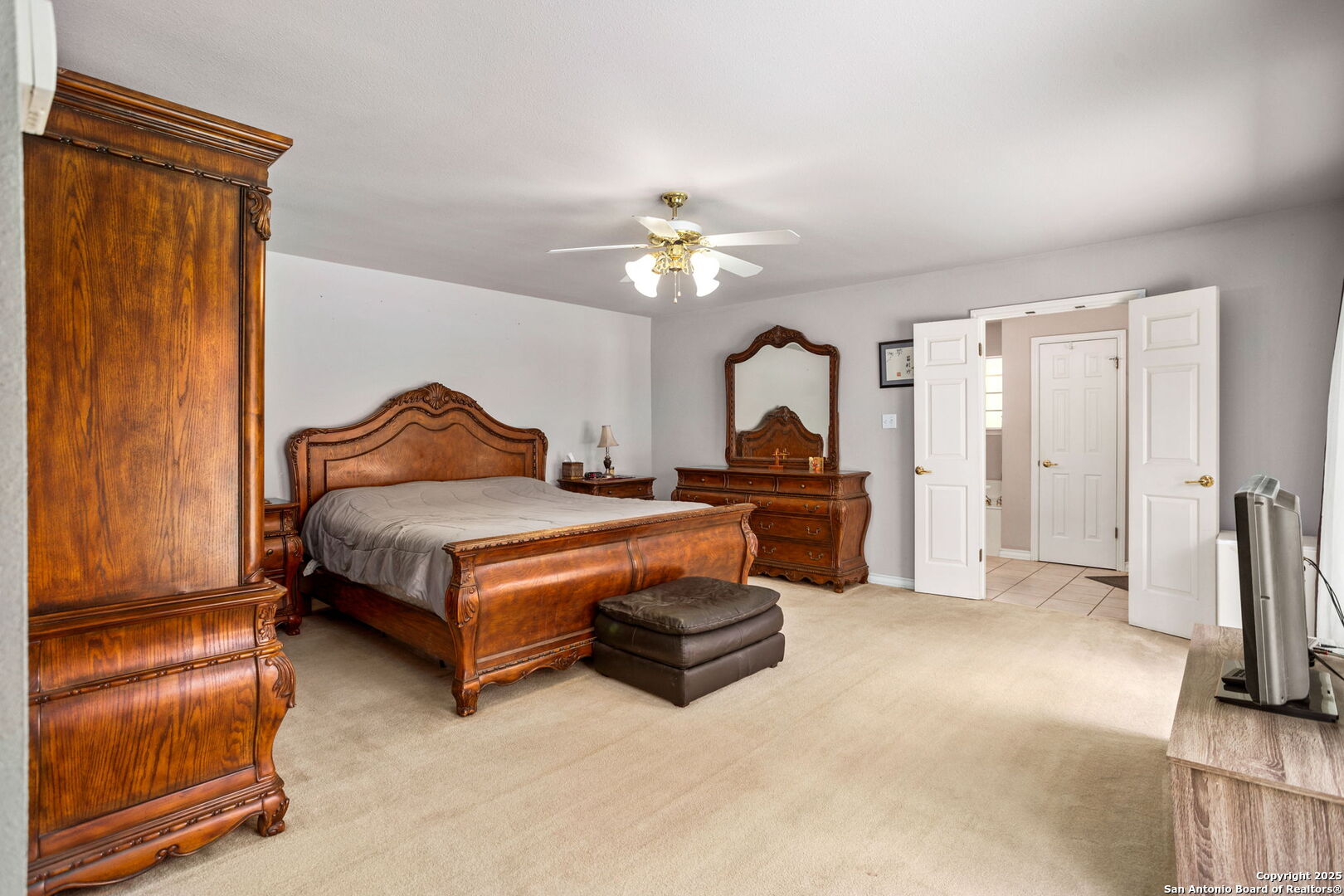 188 Guadalupe Ranch Lane Seguin, TX 78155 - Photo 27 of 40 a bedroom with a bed and a chandelier