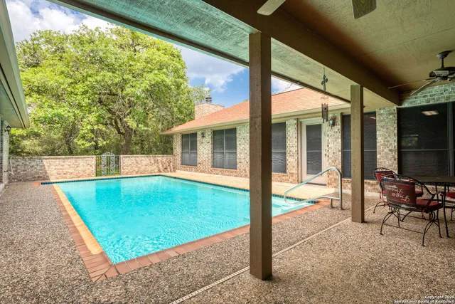 a view of a swimming pool with a lounge chair