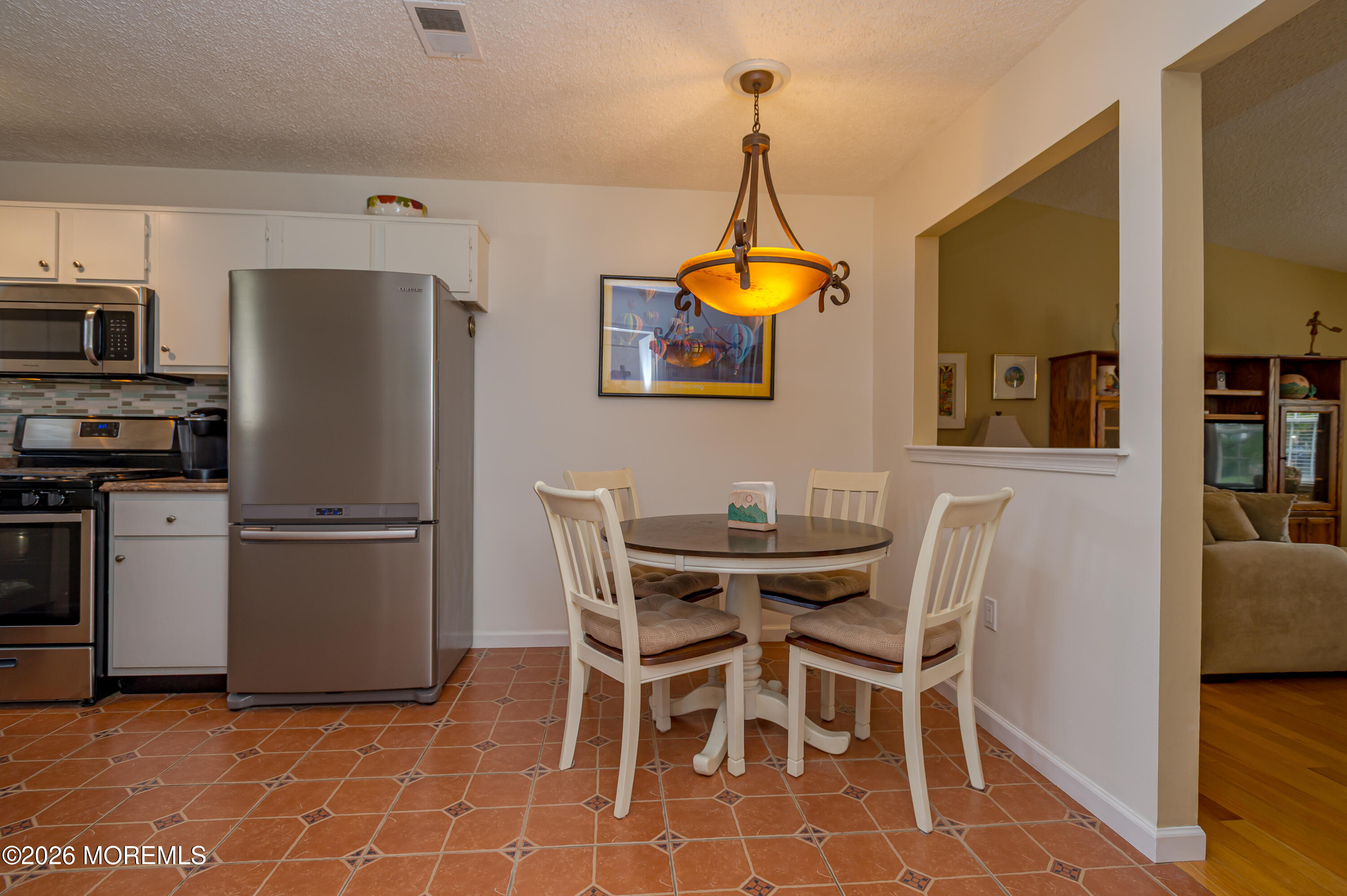 45 Datchet Close Freehold, NJ 07728 - Photo 11 of 22 a kitchen with stainless steel appliances a table chairs and a refrigerator
