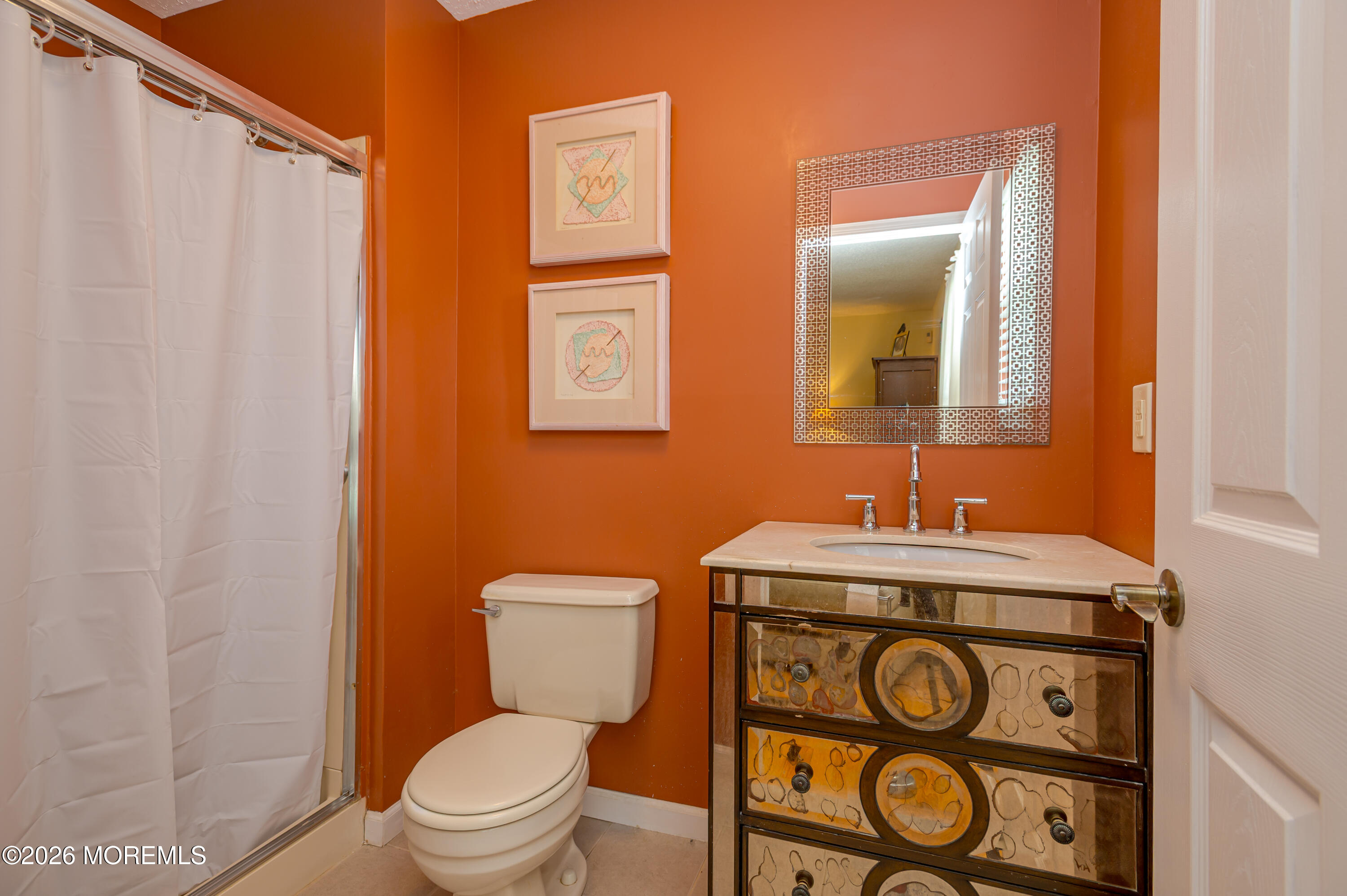 45 Datchet Close Freehold, NJ 07728 - Photo 17 of 22 a bathroom with a toilet a sink and a mirror