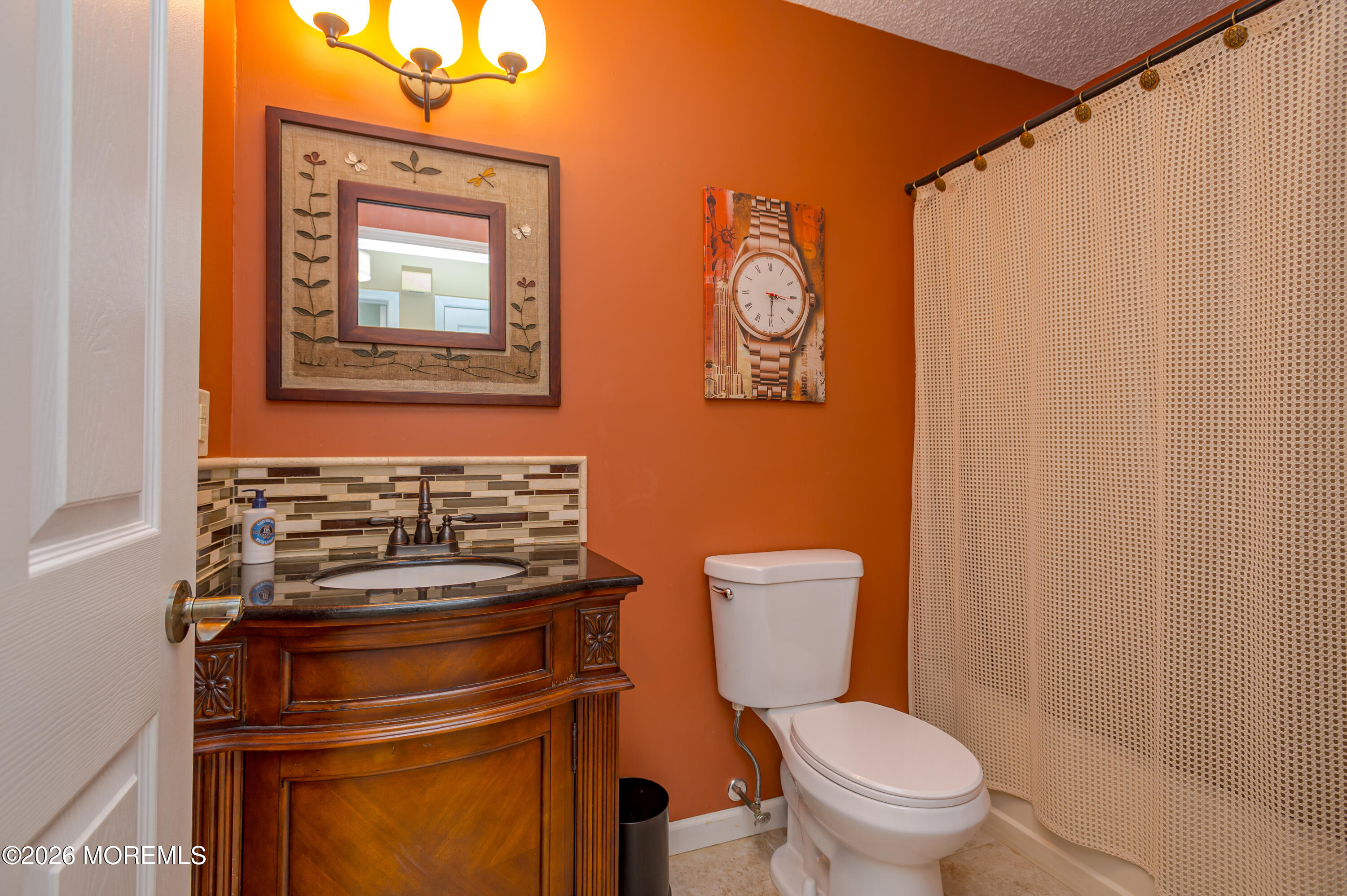 45 Datchet Close Freehold, NJ 07728 - Photo 19 of 22 a bathroom with a toilet a sink and a shower curtain