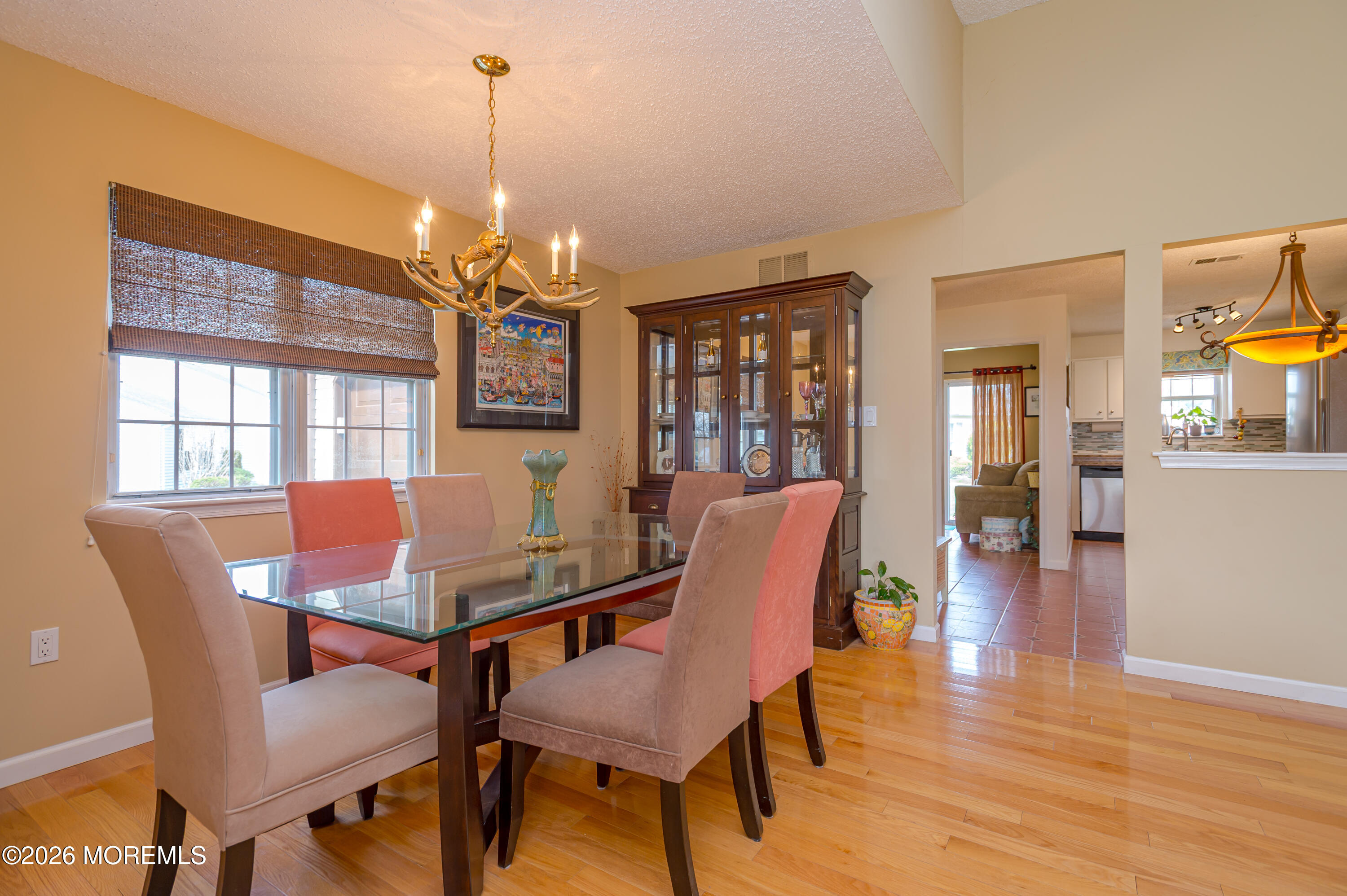 45 Datchet Close Freehold, NJ 07728 - Photo 7 of 22 a dining room with furniture a chandelier and wooden floor